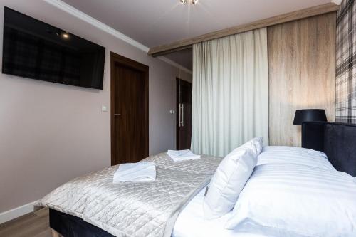 Postel nebo postele na pokoji v ubytování Aparthotel Góralski Spa & Restaurant