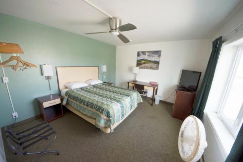 a bedroom with a bed and a ceiling fan at Rewak Studios in Fairbanks