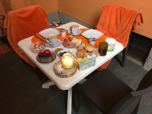 a table with food and a candle on it at B&B 21 in Cannobio