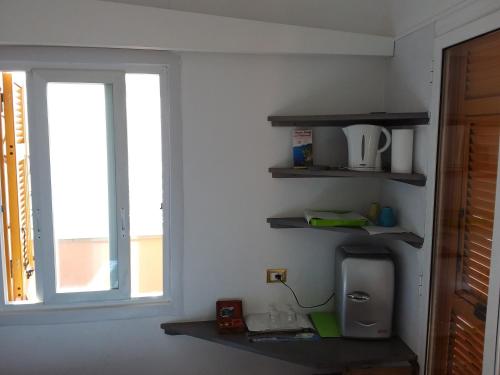 un mur avec des étagères et une fenêtre dans une chambre dans l'établissement Affittacamere Elisabetta, à Vernazza