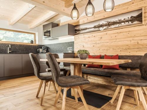 a kitchen and dining room with a wooden table and chairs at Leitnerhof in Ramsau im Zillertal