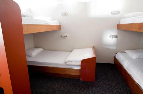 a room with two bunk beds in a room at Nautilus Beachfront Villas & Spa in Coffs Harbour