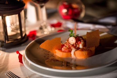 a white plate with food on a table at Vichayito Bungalows & Carpas by Aranwa Hotels in Vichayito