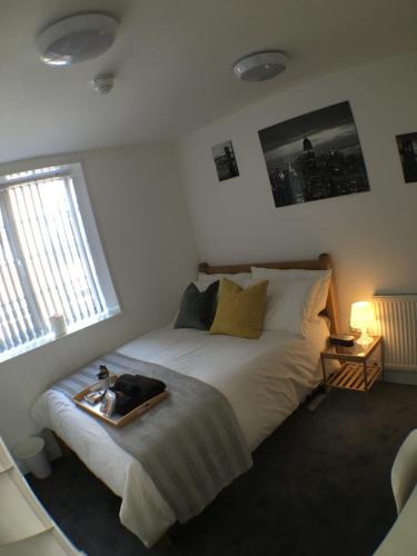 a bedroom with a bed with a tray on it at Parsons Street in Dudley