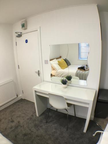 a white desk in a room with a bed at Parsons Street in Dudley