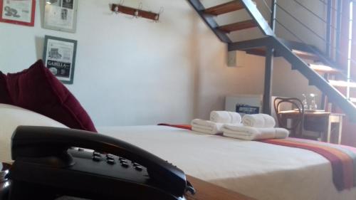 a room with a phone on a bed with towels at Hotel La Cautiva de Ramirez in La Paz