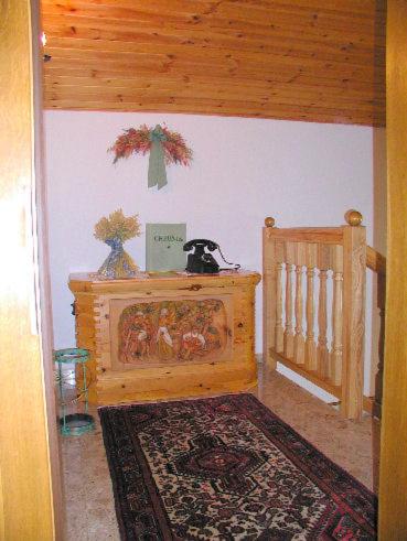 a room with a crib and a table with a rug at Landhaus Tripolt in Radstadt
