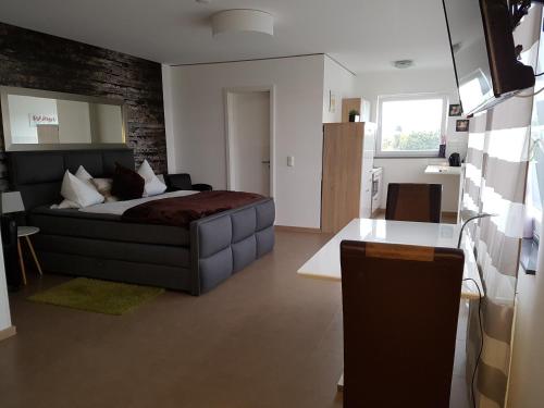 a bedroom with a bed and a brick wall at Aparthotel Magnolia in Oberursel