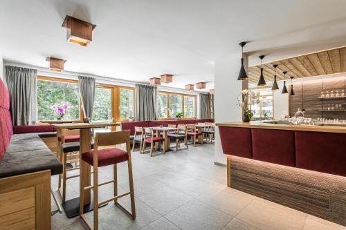 a kitchen and dining room with tables and chairs at Hotel Miramonti Badia in Badia