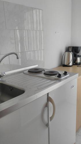 a kitchen with a sink and a counter top at Pension Zoi in Kolimbia