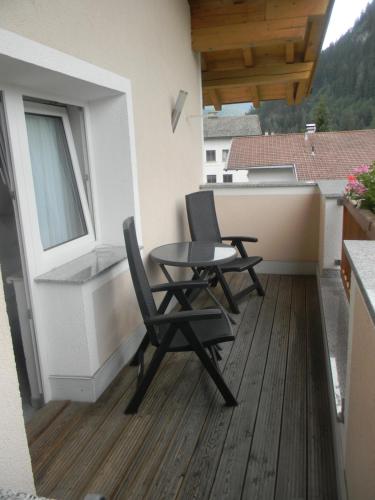 a patio with two chairs and a table on a balcony at Haus Zentner in Nauders