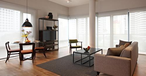 a living room with a couch and a table at E&O Residences Kuala Lumpur in Kuala Lumpur