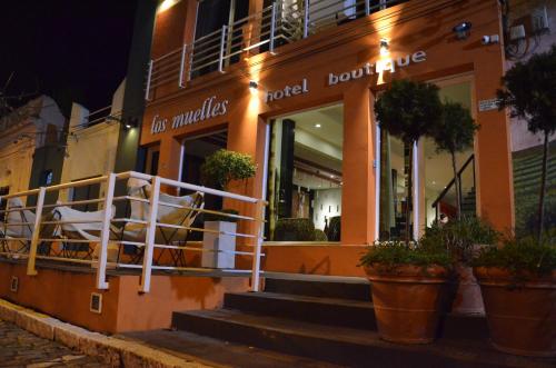 a building with stairs in front of a store at Los Muelles Boutique Hotel in Carmelo