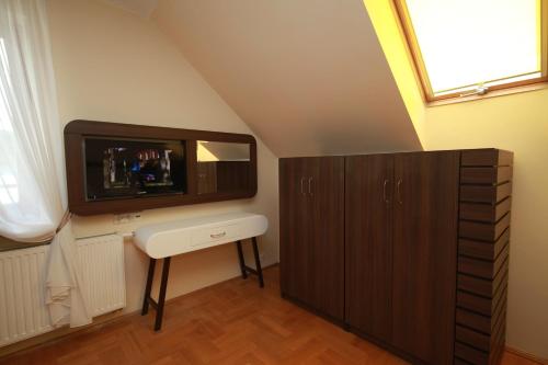 a bathroom with a sink and a tv on the wall at Willa Nova in Wisła