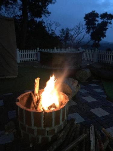 a fire pit in a yard at night at 31st December Farms And Estates Munnar in Munnar