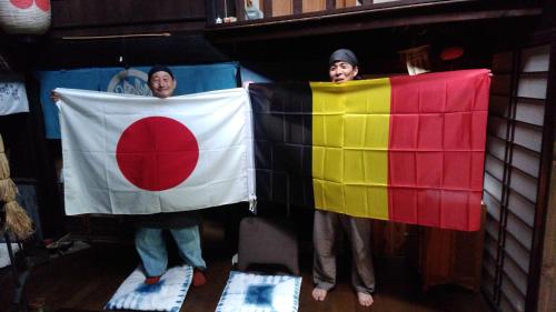 two people holding a flag in a room at Experiencing Traditional Life Style Inn Kajiya Iya Romantei in Miyoshi