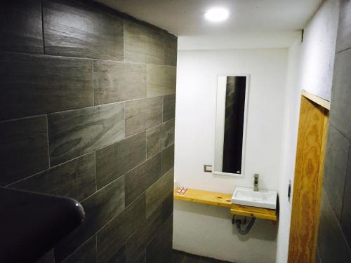 a bathroom with a sink and a mirror at Carcamanes 17 Gastro-Hotel in Guanajuato