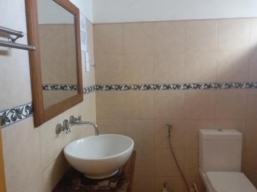 a bathroom with a sink and a toilet and a mirror at Marine Hostel at Negombo Beach Near Airport in Negombo