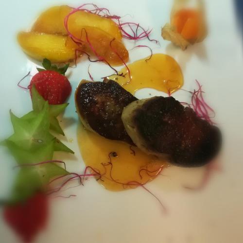 a plate of food with fruit on a plate at Hostellerie Sainte-Cécile in Florenville