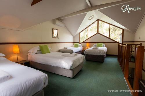 a room with three beds in a attic at Riverglen Chalets in Margaret River Town