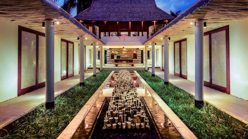 a banquet hall with tables in the middle of a building at Qunci Villas Resort in Senggigi 