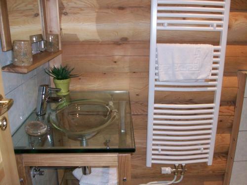 a bathroom with a glass sink and a towel rack at Chambres d'hôtes la Ferme du Canard Argenté in Provenchères-sur-Fave