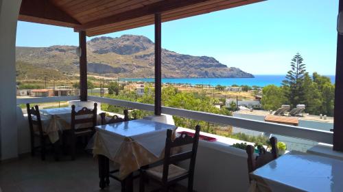a dining room with a view of the ocean at Lofos Hotel in Plakias