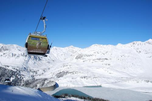 a ski lift going over a snow covered mountain at Alpenromantik-Hotel Wirlerhof in Galtür