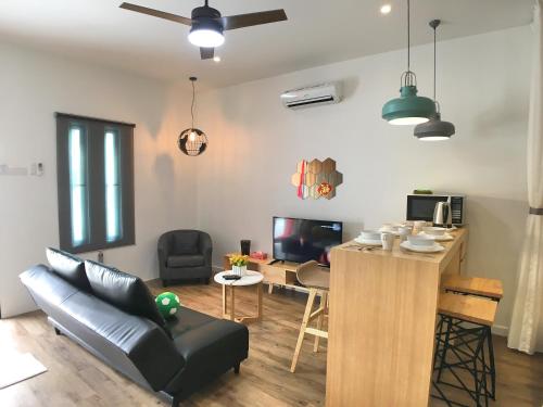 a living room with a couch and a table at iBook Gurney Suites in George Town
