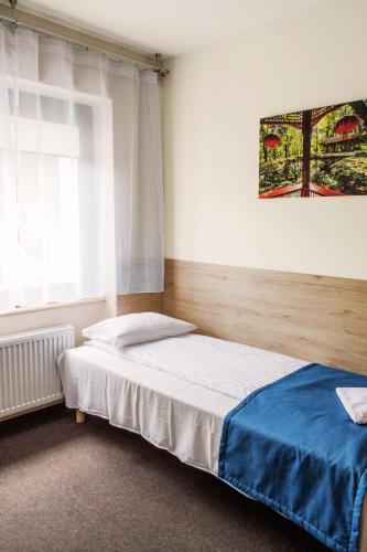a bedroom with a bed and a window at Smart2Stay Pod Lipami in Warsaw