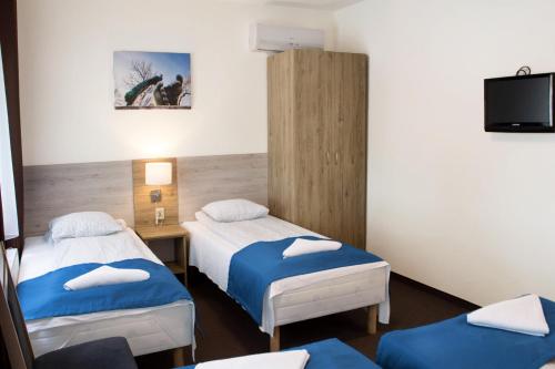 a hospital room with two beds and a tv at Smart2Stay Pod Lipami in Warsaw