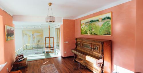 a living room with a piano and a staircase at Epp Maria Galerii in Haapsalu