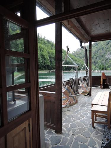 a porch with a hammock and a view of a river at Chata Motyčky in Donovaly