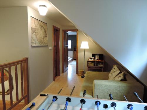 a living room with a couch and a staircase at Chata Motyčky in Donovaly