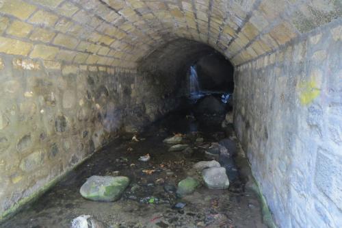 a tunnel with a pile of trash in it at River Apartments in Galata