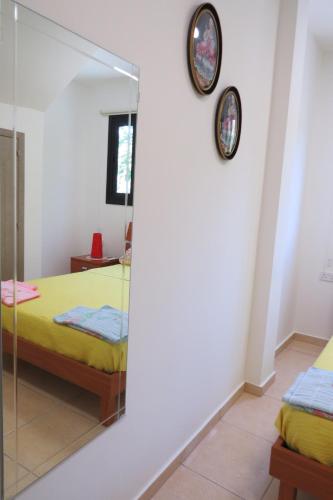 a mirror in a bedroom with two beds at River Apartments in Galata