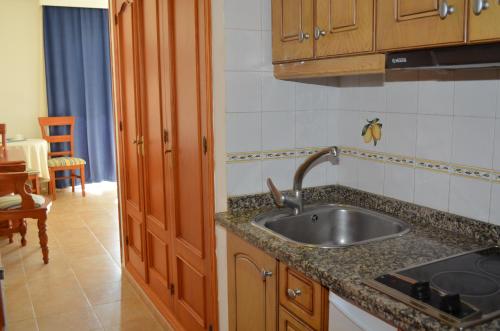 a kitchen with a sink and a counter top at Plazamar in Torremolinos