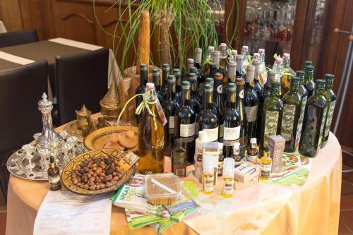 a table with a bunch of bottles of wine on it at Hotel Restaurant de l'Europe in Wissembourg