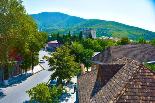 an aerial view of a town with mountains in the background at Yaffle Inn Shaki Boutique Hotel in Sheki