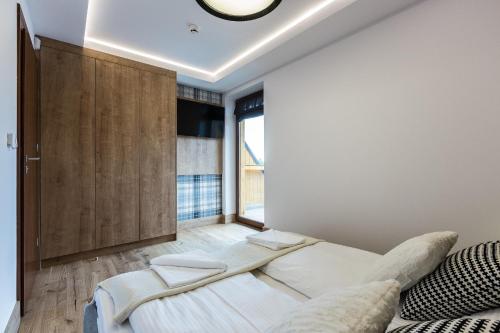 Postel nebo postele na pokoji v ubytování Aparthotel Góralski Spa & Restaurant