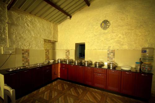 a kitchen with a bunch of pots and pans at The Pear County in Kodaikānāl