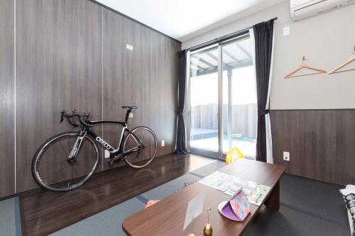 a bike is hanging on a wall in a room at Fujitaya BnB in Kyoto