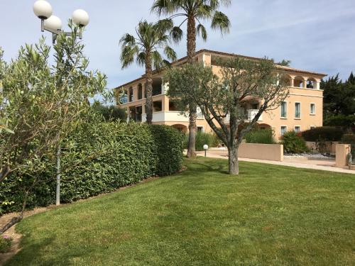a large building with trees and a grass yard at Boléro in Carqueiranne