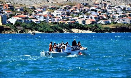 a group of people on a boat in the water at Apartments Lidija in Pag