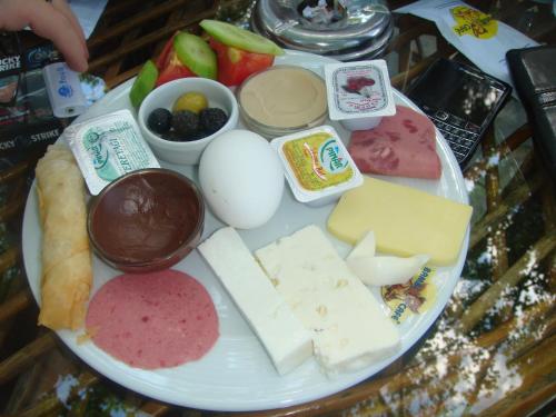 a plate of cheese and other foods on a table at Taksim Palace Hotel in Istanbul