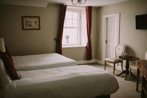 a hotel room with two beds and a window at Royal Valentia Hotel in Valentia Island