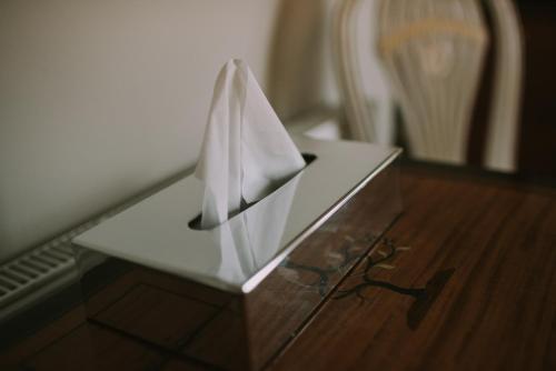 a box with a napkin on a table with a chair at Royal Valentia Hotel in Valentia Island