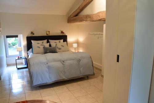 a bedroom with a large bed in a room at Moulin De Ladausse in Monflanquin