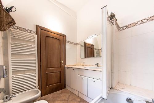 a bathroom with a sink and a toilet and a tub at B&B Finalex in Finale Ligure