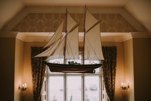 a model ship hanging from a ceiling in a room at Royal Valentia Hotel in Valentia Island